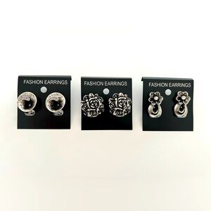 Silver toned fashion flower shaped earrings with a vintage look.